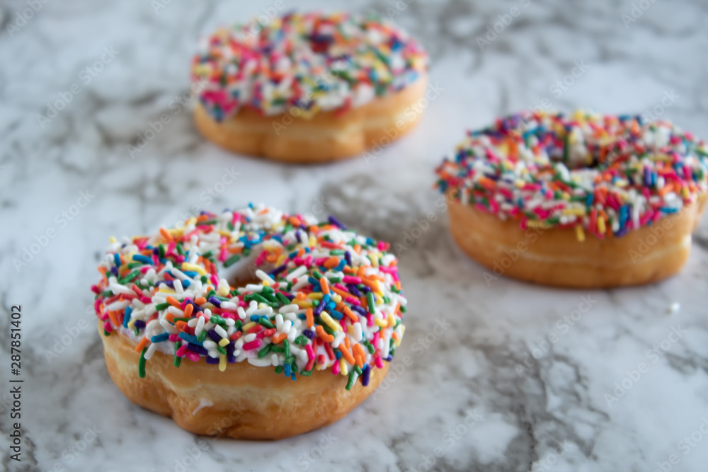 Donuts with white icing and sprinkles Donuts with white icing and sprinkles