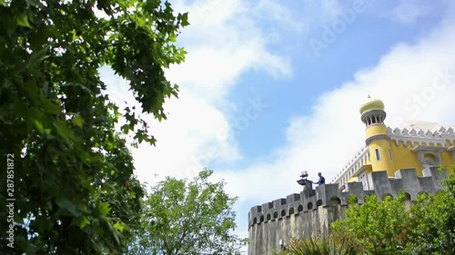 Pan over beautiful vegetation and walls of the National Palace of Pena, Sintra, Portugal