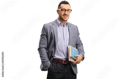 Fotografie, Obraz Young man holding books and smiling at the camera