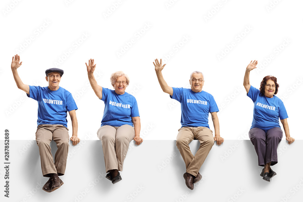 Elderly volunteers sitting on panel and waving Elderly volunteers sitting on panel and waving