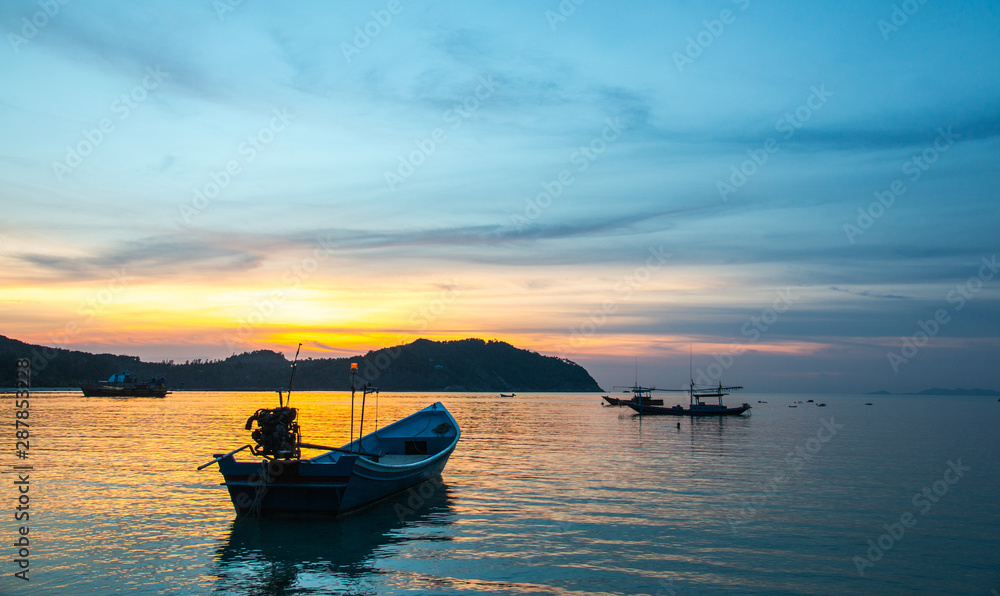 Fishermen boat at sunset near Koh Phangan island, Thailand Fishermen boat at sunset near Koh Phangan island, Thailand