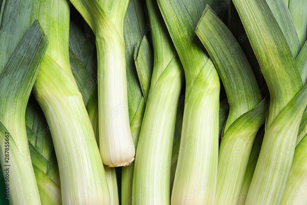 Fresh raw leeks as background, closeup. Ripe onion Fresh raw leeks as background, closeup. Ripe onion