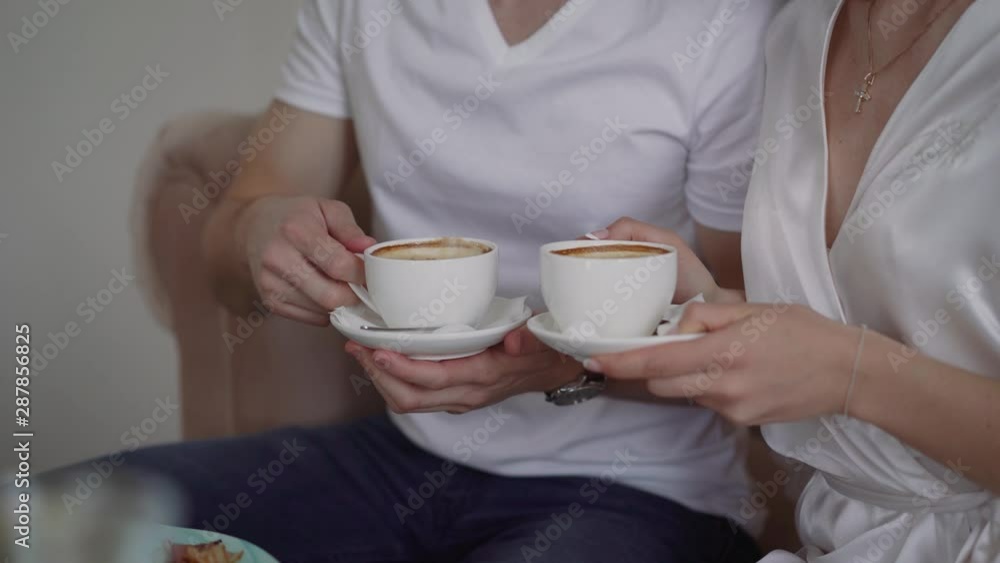 Man proposes gives coffee in white little cup to his girlfriend or partner, they are in love and are on romantic date in downtown stylish cafe or restaurant, drink artisan specialty Man proposes gives coffee in white little cup to his girlfriend or partner, they are in love and are on romantic date in downtown stylish cafe or restaurant, drink artisan specialty