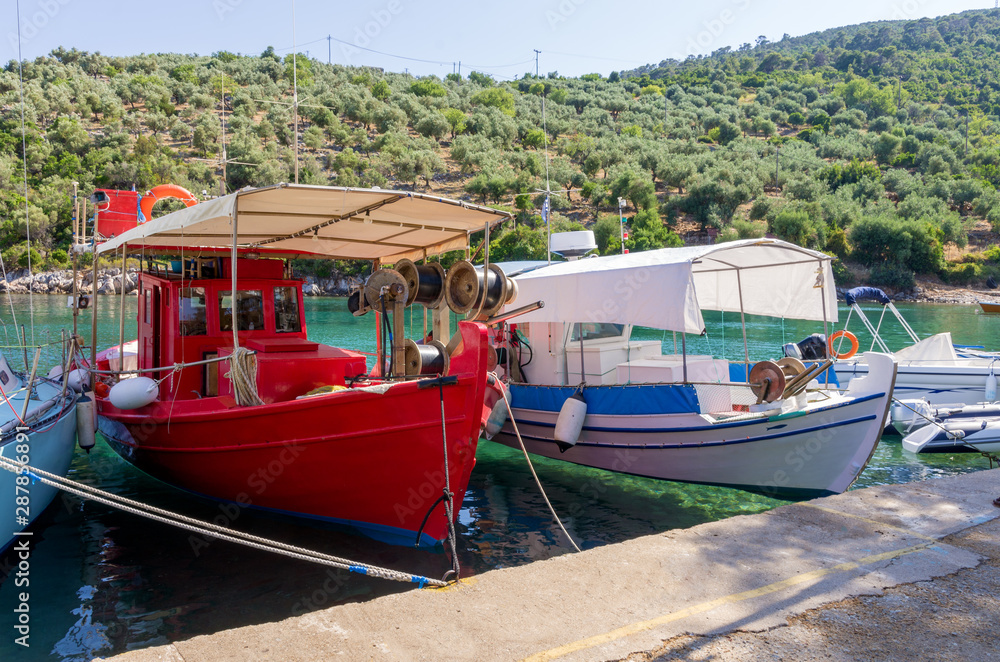 Fishing boats in the picturesque little harbor of Steni Vala village, Alonnisos island, Greece