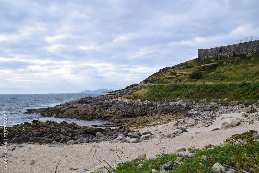 View of the beach of os frades in Baiona (Spain). Small beach located next to the fortress of Monterreal