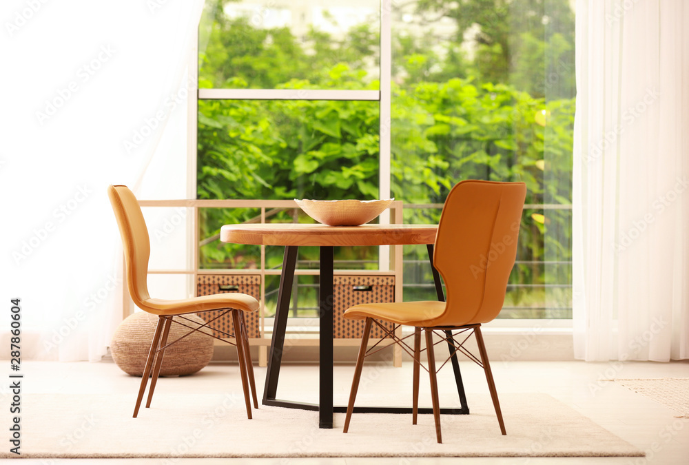 Obraz premium Modern dining room interior with table and chairs
