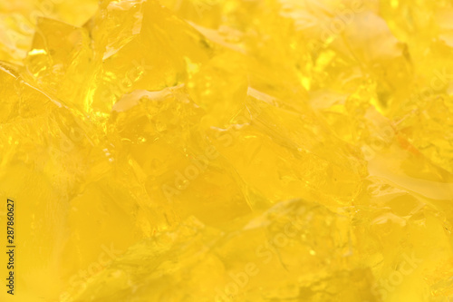 Yellow tasty fruit jelly as background, closeup photo