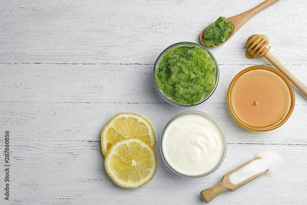 Handmade face mask made and different ingredients on white wooden table, flat lay. Space for text Handmade face mask made and different ingredients on white wooden table, flat lay. Space for text