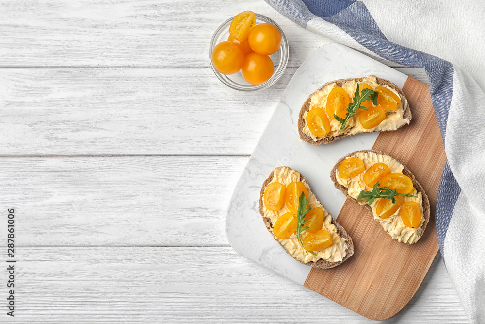 Tasty fresh tomato bruschettas on white wooden table, flat lay. Space for text Tasty fresh tomato bruschettas on white wooden table, flat lay. Space for text