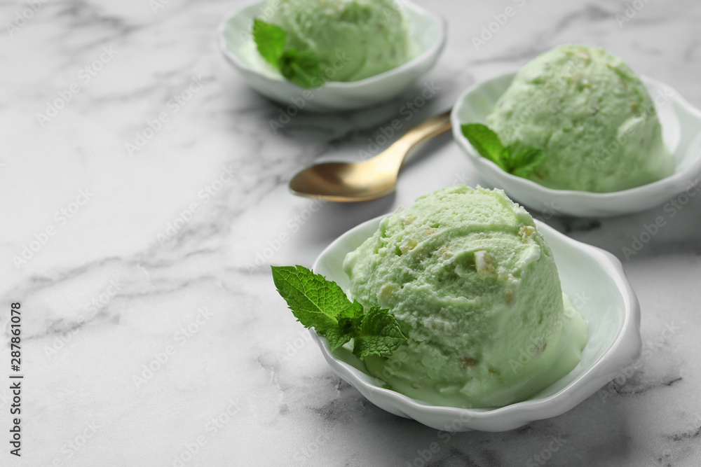 Delicious pistachio ice cream on marble table. Space for text Delicious pistachio ice cream on marble table. Space for text