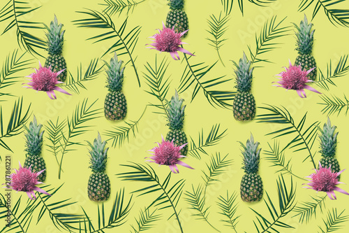 Creative seamless tropical pattern with flowers and pineapples on pink pastel background. Nature concept