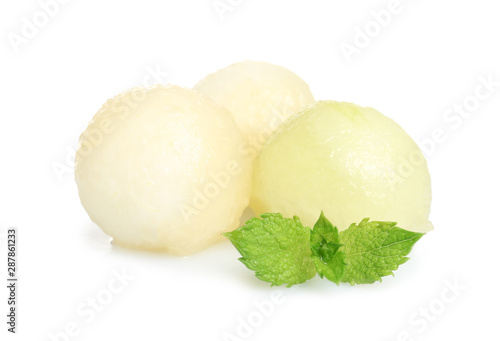 Juicy sweet melon balls with mint on white background