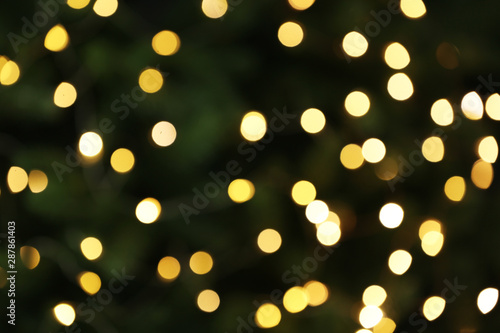 Abstract background with blurred yellow Christmas lights, bokeh effect