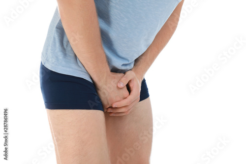 Man suffering from pain on white background, closeup. Urology problems