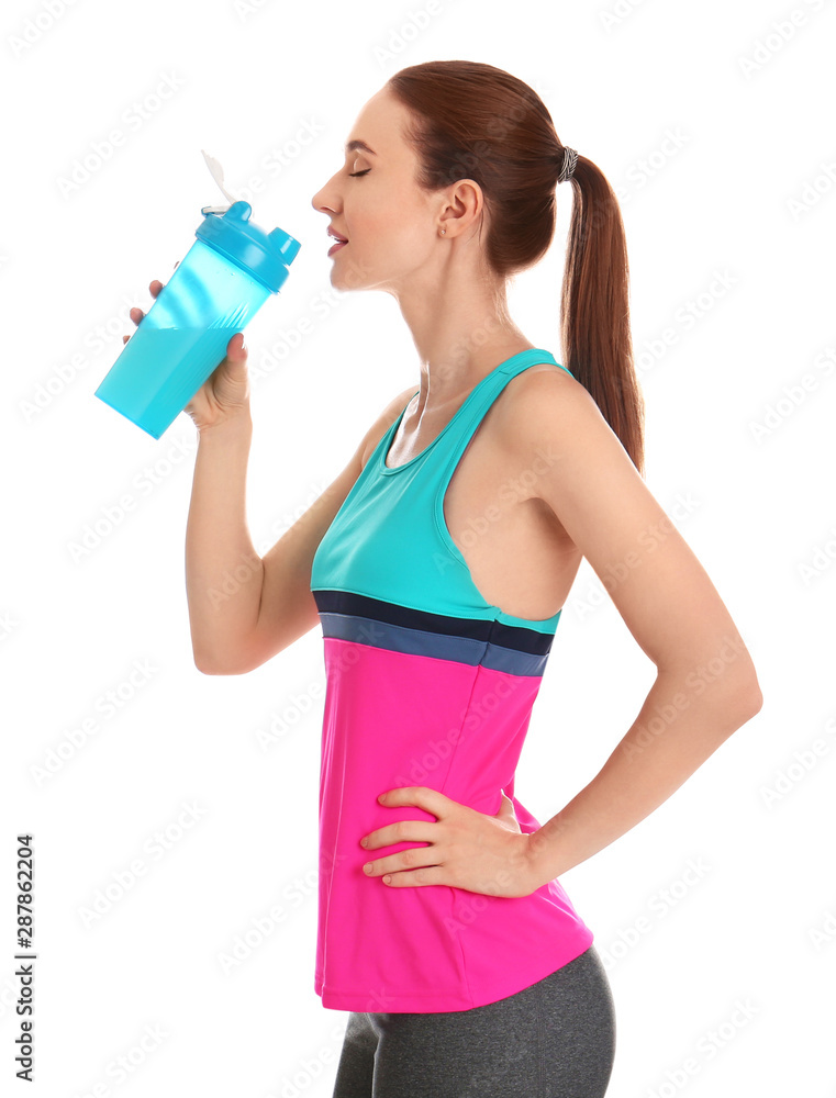 Athletic young woman drinking protein shake on white background Athletic young woman drinking protein shake on white background