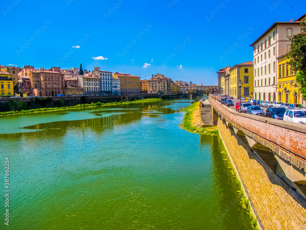 View of the Arno River with the Ponte Vecchio (Old Bridge) in the background. In Florence, Italy