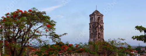Panoramic View of a Church in a small touristic Cuban Town during a vibrant sunny sunrise. Taken in Trinidad, Cuba.