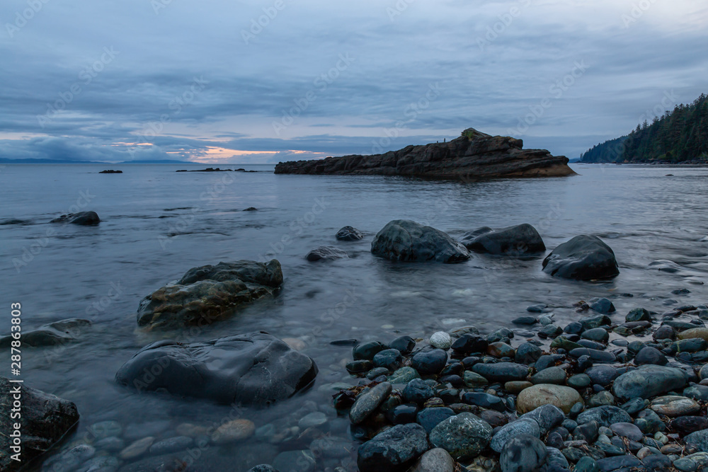 Beautiful View of a rocky beach on the Juan de Fuca Trail during a summer sunset. Taken at Chin Beach, near Port Renfrew, Vancouver Island, BC, Canada.
