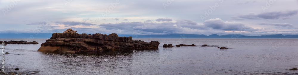 Beautiful Panoramic View of a rocky beach on the Juan de Fuca Trail during a summer sunset. Taken at Chin Beach, near Port Renfrew, Vancouver Island, BC, Canada.