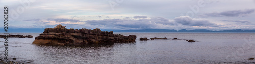 Beautiful Panoramic View of a rocky beach on the Juan de Fuca Trail during a summer sunset. Taken at Chin Beach, near Port Renfrew, Vancouver Island, BC, Canada.