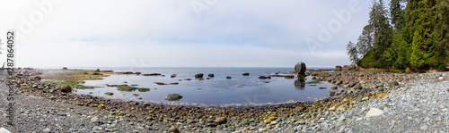Beautiful Panoramic View of a rocky beach on the Juan de Fuca Trail during a misty summer morning. Taken at Bear Beach, near Port Renfrew, Vancouver Island, BC, Canada.