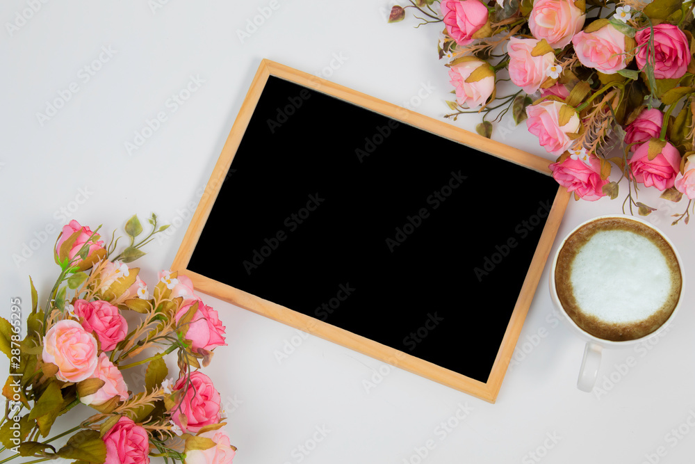 Top view flat lay wedding background concept with chalkboard mock up frame and beautiful pink rose bouquet flowers decorations on white background