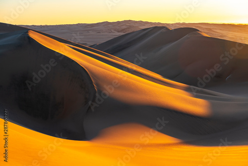 Fototapeta Naklejka Na Ścianę i Meble -  Sunset in the sand dunes and desert between Ica and Huacachina, Peru, South America.
