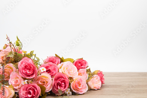 Selective focus Beautiful pink rose bouquet composition on wooden table for wedding or anniversary concept with copy space