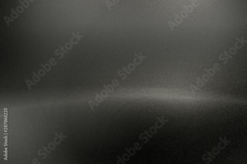 Brushed black metal wall with scratched surface, abstract texture background