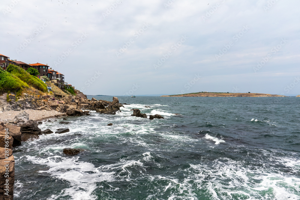 The rocky coast of the Black Sea near the ancient city of Sozopol. Bulgaria. In the In the background are the islands of St. Peter and St. Ivan. The rocky coast of the Black Sea near the ancient city of Sozopol. Bulgaria. In the In the background are the islands of St. Peter and St. Ivan.