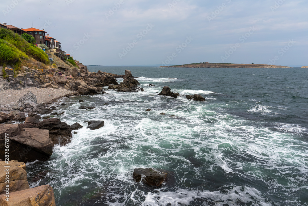 Obraz premium The rocky coast of the Black Sea near the ancient city of Sozopol. Bulgaria. In the background are the islands of St. Peter and St. Ivan.