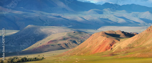 Panoramic view of mountains in the south of Altay, Mongolian landscapes. Dry mountain slopes and evening light.