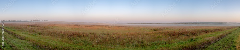 Morning fog in the fields with copses. Zavyalovsky district, Udmurt Republic, Russia.