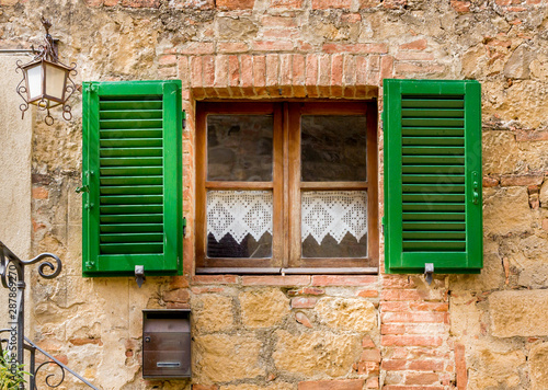 Traditional Tuscan home with green shutters