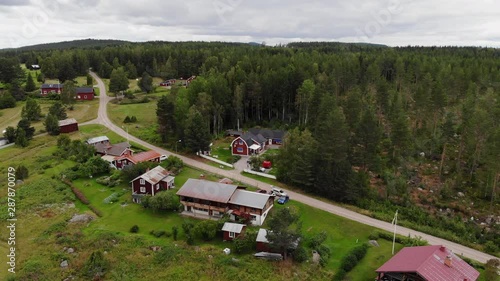 Drone flight over small village and trees in Sweden photo