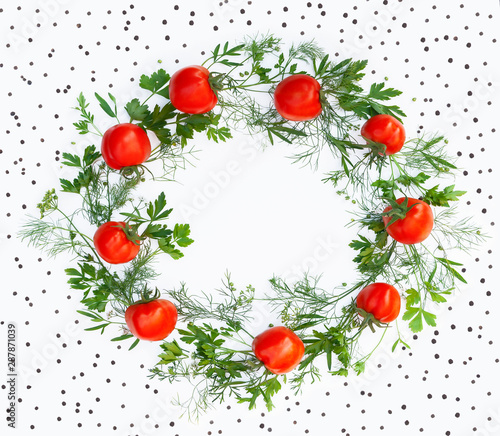 Wreath made of fresh tomato and greens as a frame