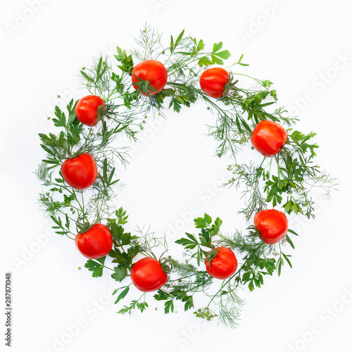 Wreath made of fresh tomato and greens as a frame