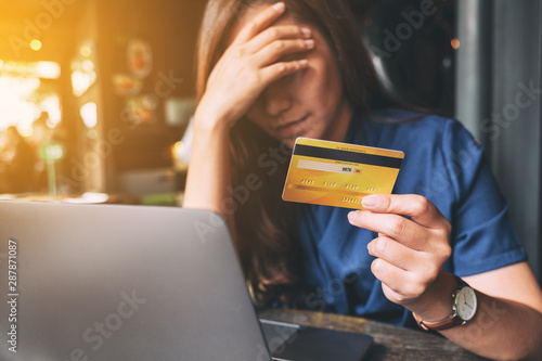 Closeup image of an Asian woman get stressed and broke while holding credit card photo