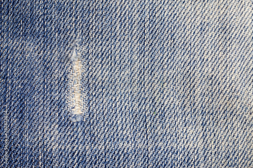 Jeans torn denim texture background.