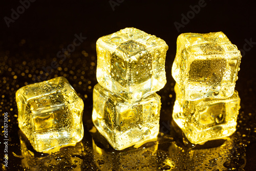 ice cubes on a reflections yellow light.