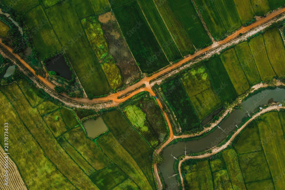 Fototapeta premium aerial view of road and devious river in a fields