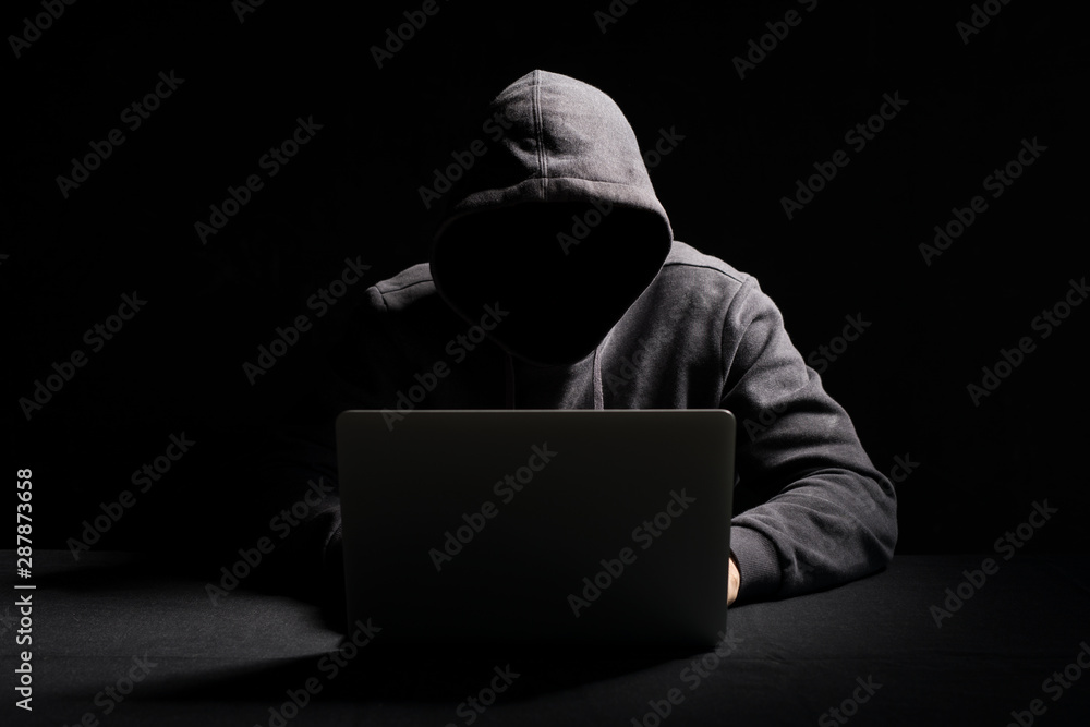 Hacker working on laptop in the dark - obrazy, fototapety, plakaty 