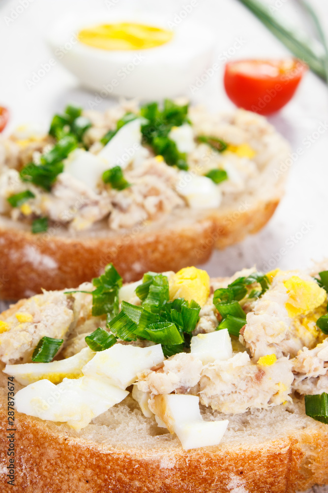 Closeup of baguette with fresh mackerel or tuna fish paste, healthy nutrition concept