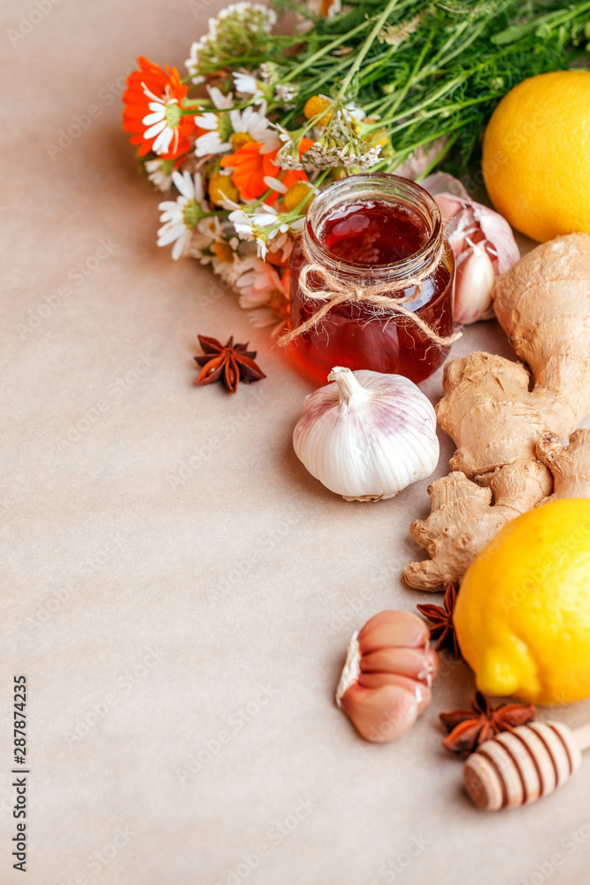 Lemon ginger honey herbs on table. Ingredients for Warm drink beverage for cold flu winter fall days. Copy space background, alternative medicine treatment concept Lemon ginger honey herbs on table. Ingredients for Warm drink beverage for cold flu winter fall days. Copy space background, alternative medicine treatment concept