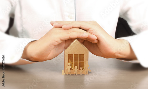  Wooden toy house. Mortgage property home concept. Buying house for family.