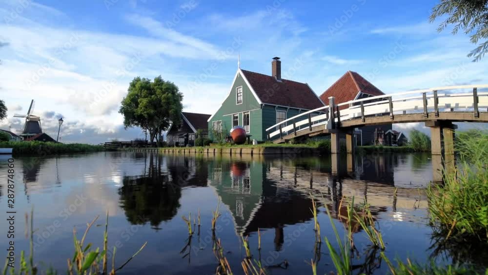 Cheese factory building at Zaanse Schans reflected on the calm canal water, in Zaandam, Neterlands Cheese factory building at Zaanse Schans reflected on the calm canal water, in Zaandam, Neterlands