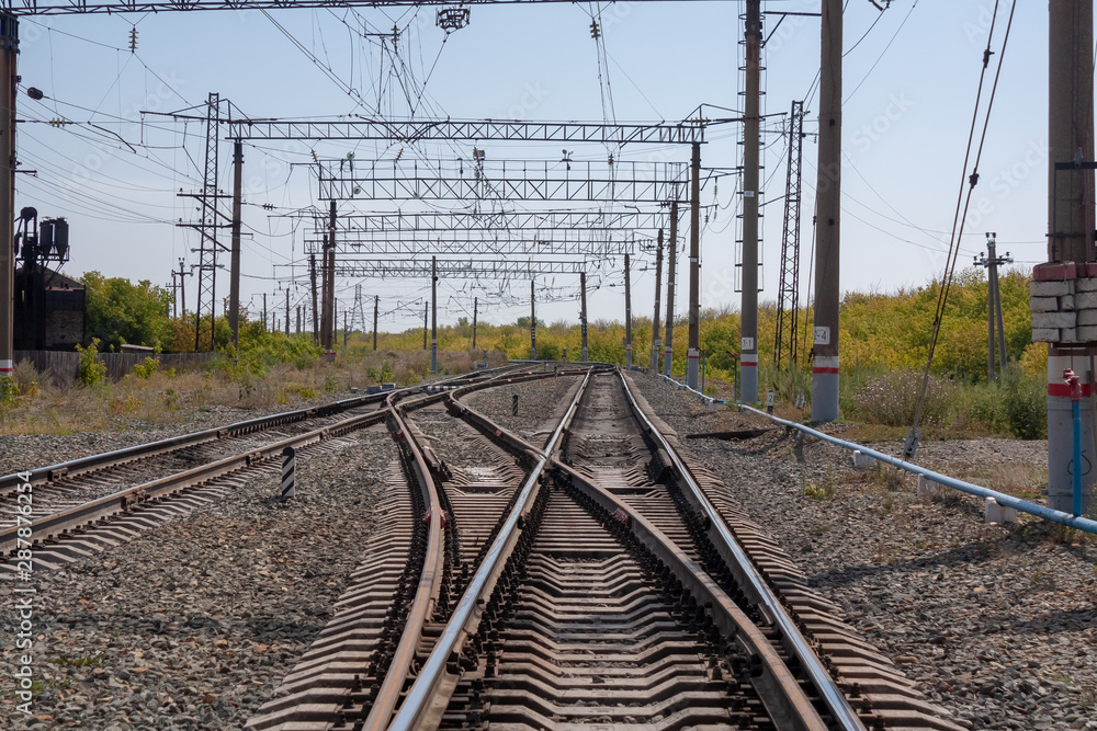 the railway stretching into the horizon under the blue sky the railway stretching into the horizon under the blue sky
