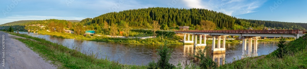 Road bridge over the river Usva in the village of Usva. Gremyachinsky district, Perm Krai, Russia. Panorama.