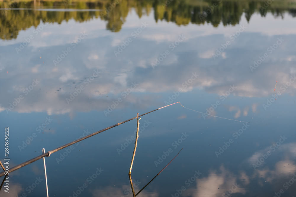 Fototapeta premium fishing gear. fishing rods. fishing rods standing on a fishing trip. landscape of a fisherman.