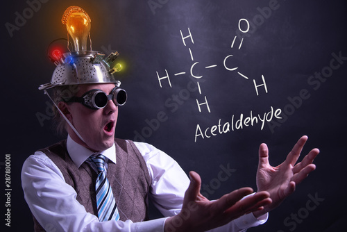 Nerd presenting handdrawn chemical formula of acetaldehyde